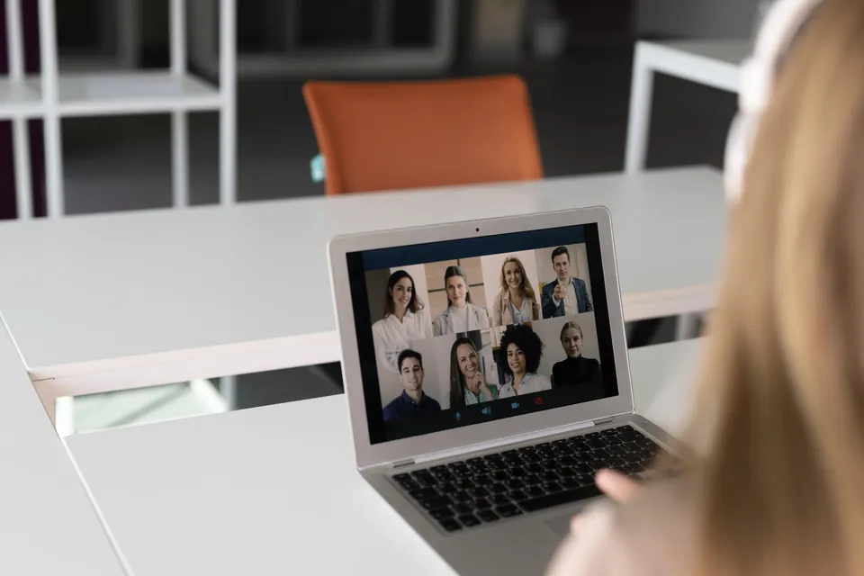 A person joining a team video call on a laptop